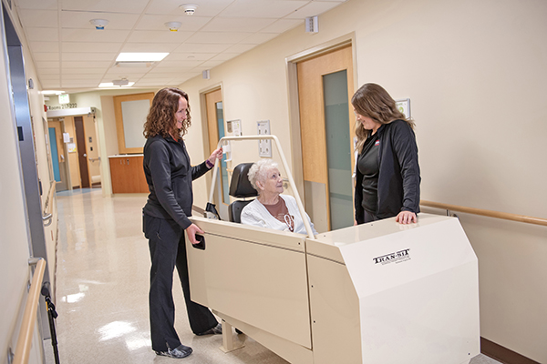 Lincoln Memorial Hospital colleagues transporting patient with swing bed equipment