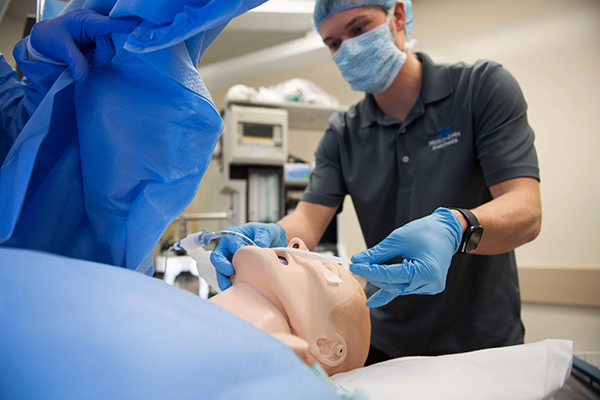 Decatur Memorial Hospital employee practices procedure skills on mannequin